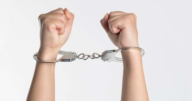 Hands in handcuffs, white male, likely a teen