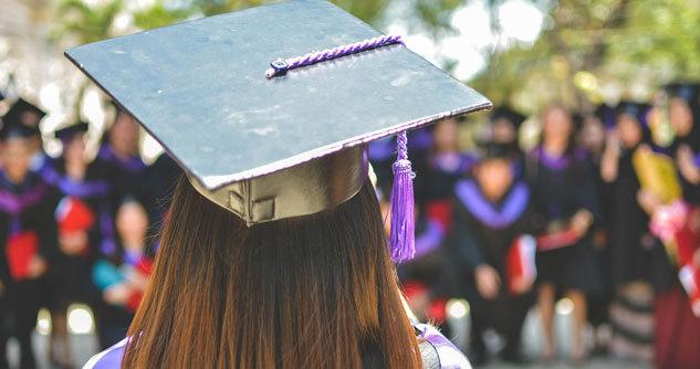 Graduation pic from stage, back of female grad head looking at crowd