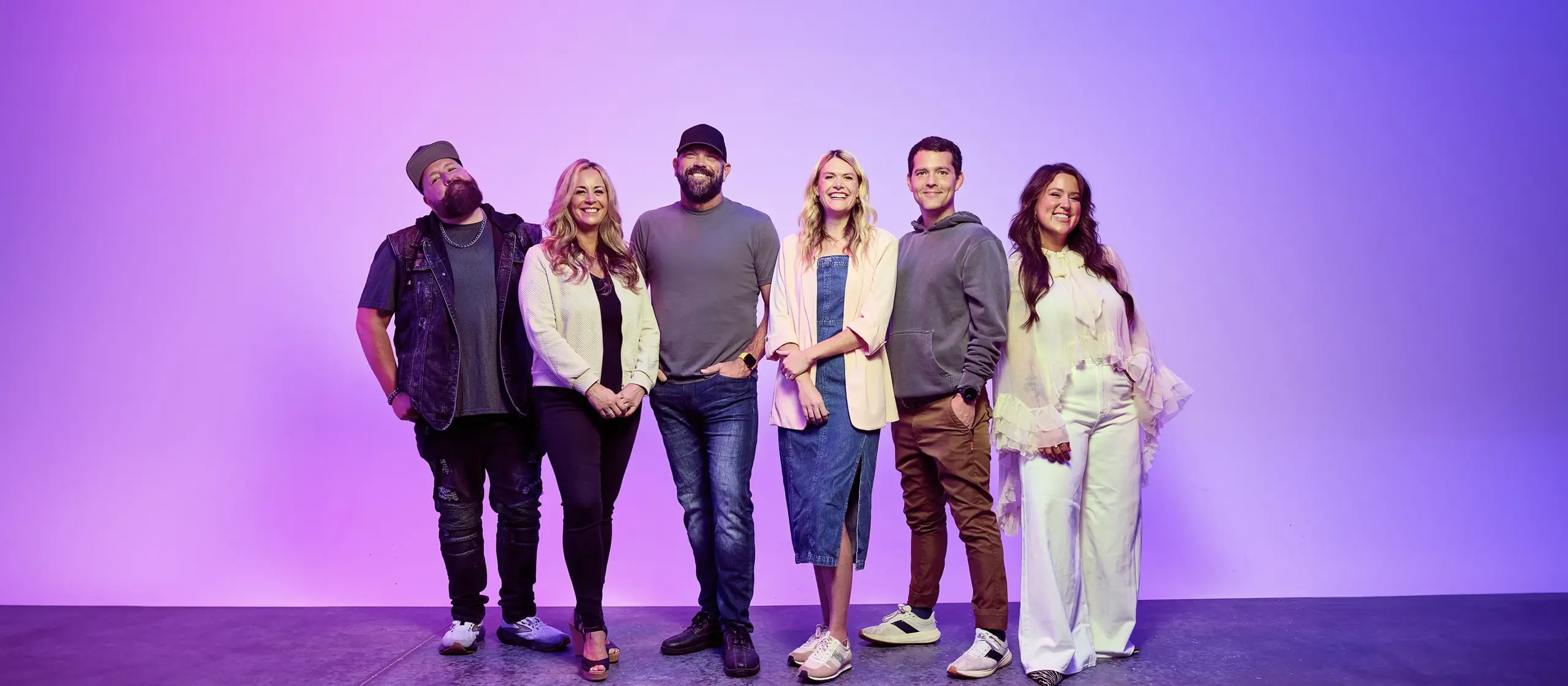 The Air1 DJs sitting outside the Air1 building in lineup order